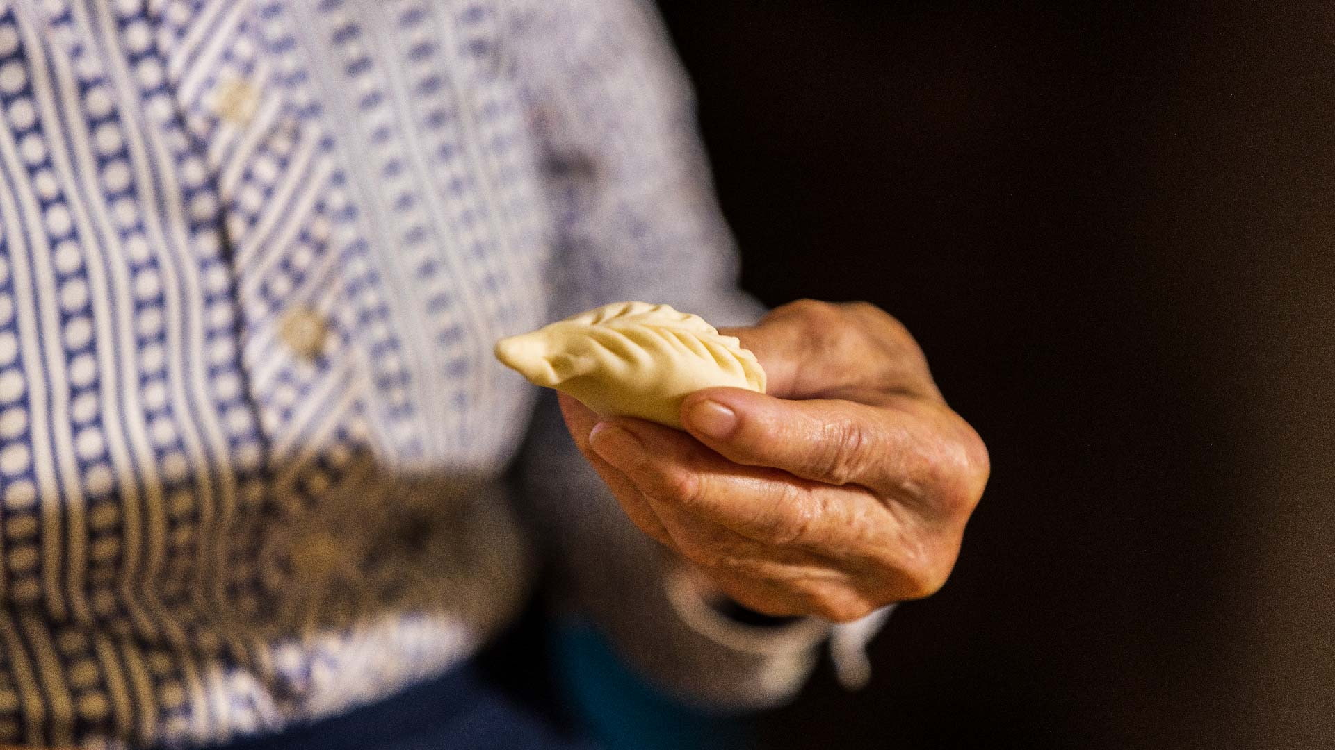 A woman's hands holding a freshly hand-sealed culurgione