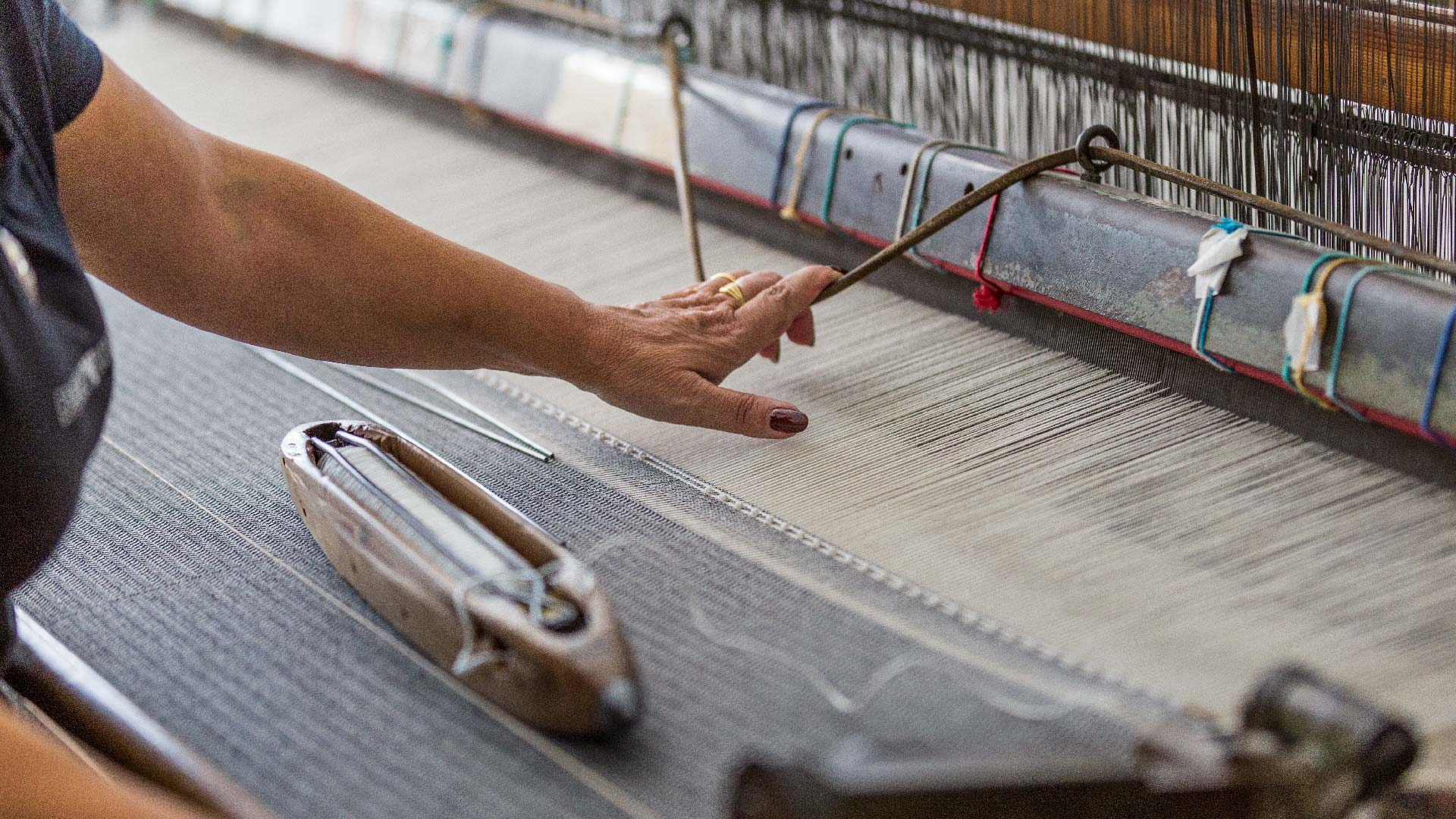 Weaver working a rug on a traditional loom in Ogliastra